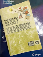 My Scout Handbook, superimposed on the cover of Intermediate Physics for Medicine and Biology.