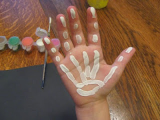 preschooler paints hand bones