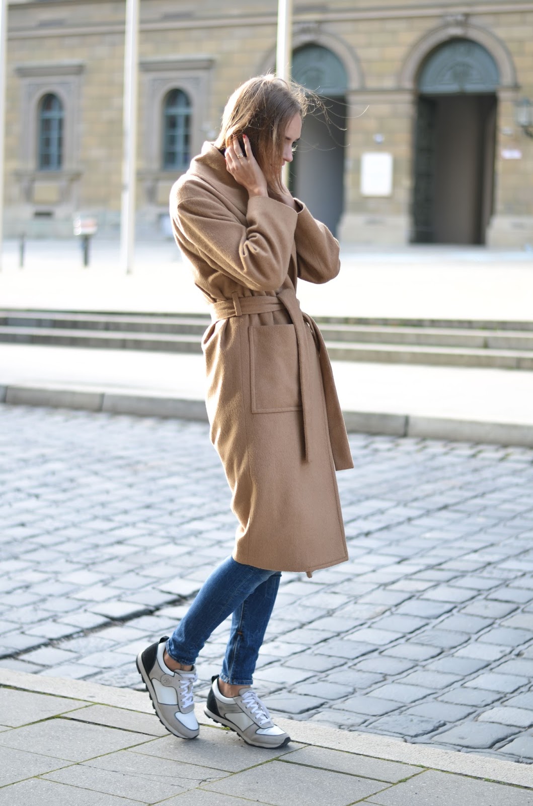 kristjaana mere minimalist camel coat outfit with sneakers