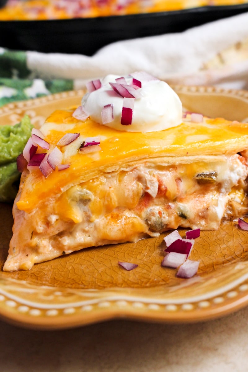 Cheesy Chicken Tortilla Pie is made with layers of flour tortillas, shredded chicken, salsa, plain greek yogurt and lots of melty, delicious cheese.  You will love how quickly this easy dinner recipe comes together! #chickenrecipe #mexicanfood #casserole