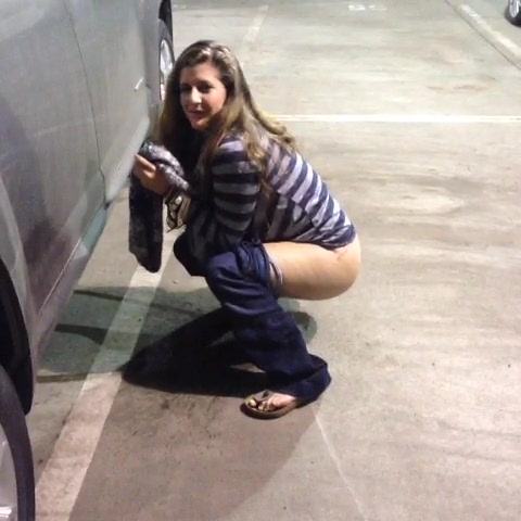 YTPeeClip0774: Blond girl pees in a parking lot (short clip) .