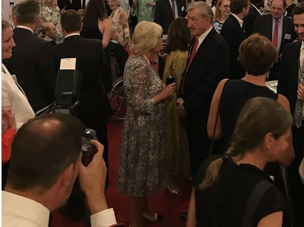 Duchess of Cornwall attended a reception at Buckingham Palace to mark the 50th Anniversary of the Man Booker Prize. Duchess wore print summer dress