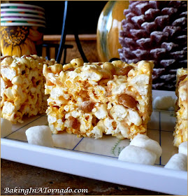 Caramel Studded Popcorn Treats, made with toasted coconut marshmallows, crunchy popcorn and studded with caramel candies, this treat is quick and easy to make and fun to serve. | Recipe developed by www.BakingInATornado.com | #recipe #treat