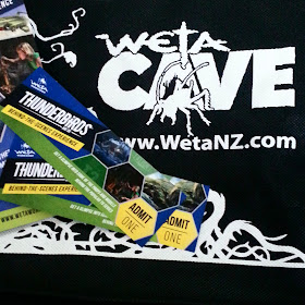 Tickets to the Weta Cave Thunderbirds behind-the-scenes tour displayed on a  Weta Cave shopping bag.