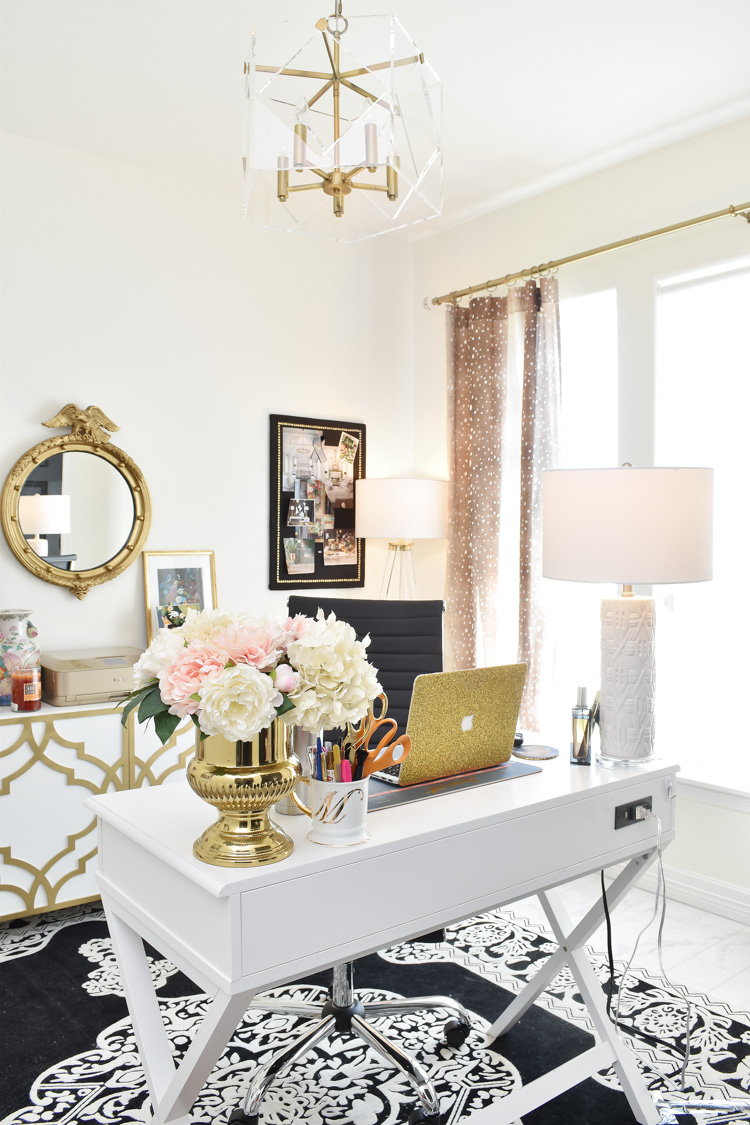A STUNNING home office with perfect lighting and black, white and gold decor and accents. Love the antelope curtains and alabaster white walls.