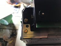 Bolts holding the power connector in place