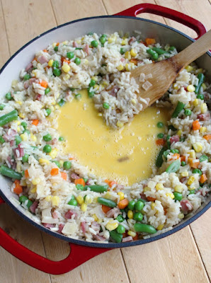 Make pork fried rice without leftover rice. This simplified recipe comes together quickly, tastes great and starts with uncooked white rice! scrambled egg mixture in the middle of a pan of almost ready fried rice
