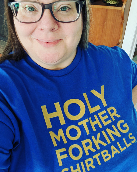 image of me from the chest up wearing a blue t-shirt that reads HOLY MOTHER FORKING SHIRTBALLS