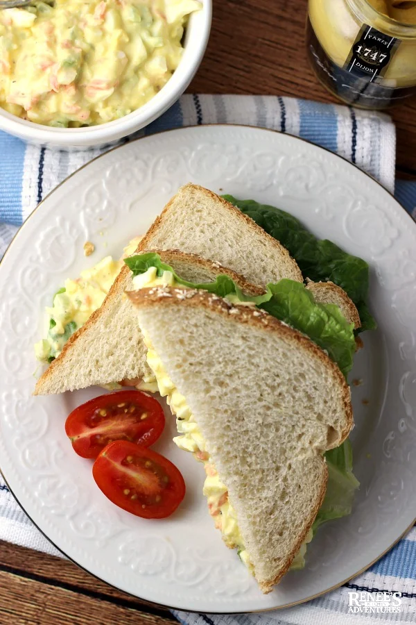 Egg Salad Sandwich on plate with bowl of egg salad