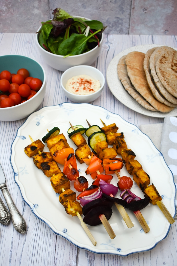 Grilled Tandoori Tofu Skewers served with wholemeal pitta bread, salad leaves, cherry tomatoes and hummus