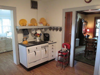 Vintage Chambers stove model B blacktop in corner of retro kitchen with vintage plates and bowls, Lombard, Illinois