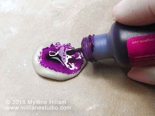 Epoxy Resin Clay being coloured with purple alcohol ink