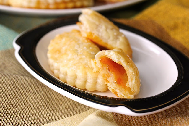 These Apricot Pochettes are reminiscent of little French pastry desserts. They are made with a cream cheese and butter pastry dough, and are filled with just a bit of apricot preserves.