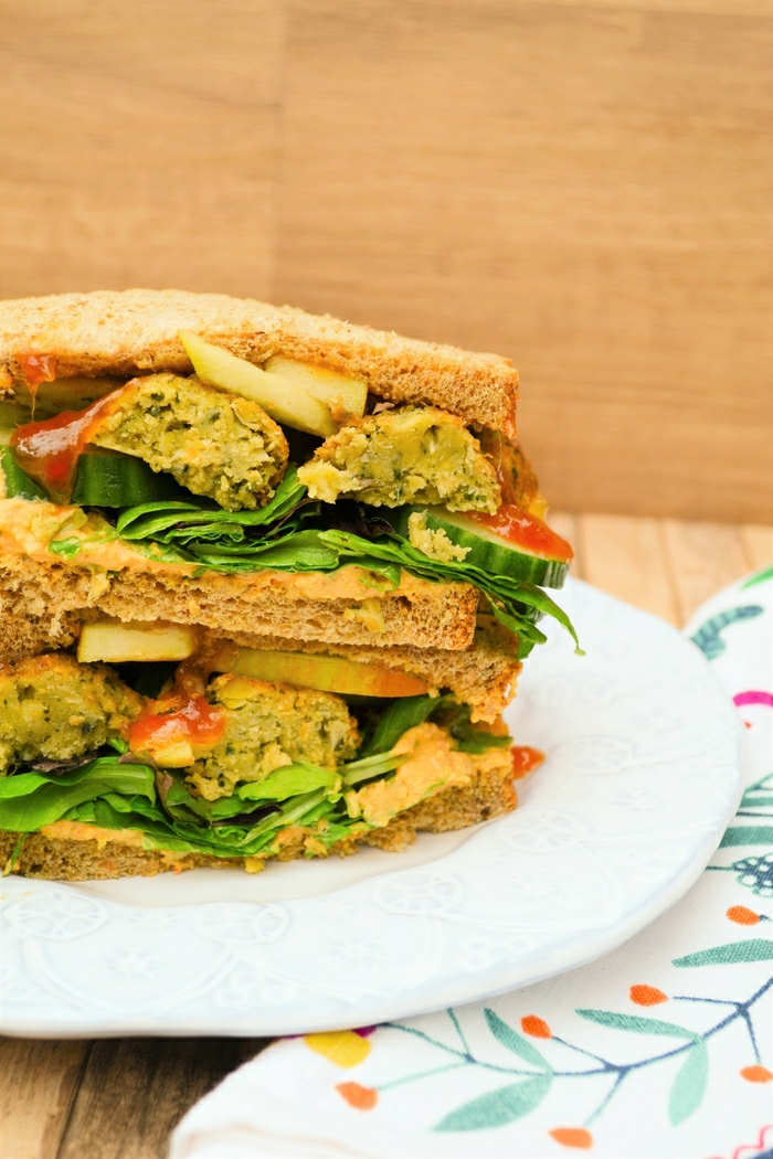 A delicious vegan sandwich. Sweet crunchy apple with lightly spiced falafel, creamy hummus and fresh salad on soft brown bread with a sweet bit of heat from some mango chutney. Plus 15 family sandwich ideas.