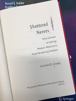 Shattered Nerves: How Science is Solving Modern Medicine's Most Perplexing Problem, by Victor Chase, superimposed on Intermediate Physics for Medicine and Biology.