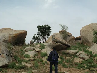 Hiker explore the open land beyond the Mandaragiri hillock