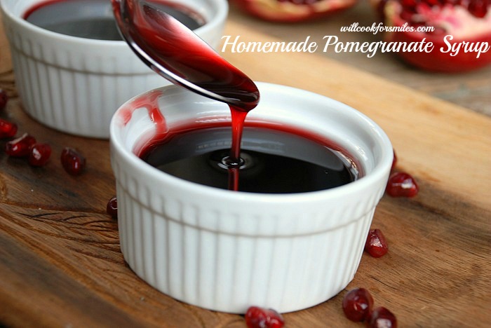 Pomegranate syrup in ramekin with a spoon pouring some into the ramekin 