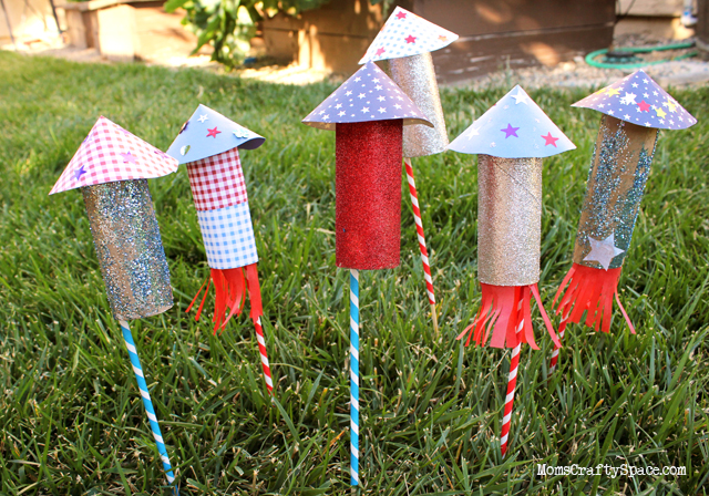 many crafted rockets set up in yard