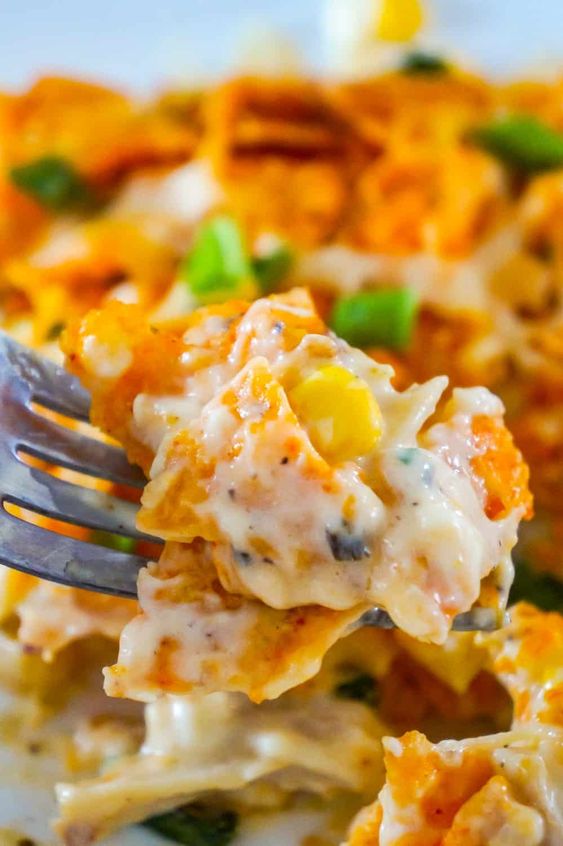 Doritos Casserole with Chicken is an easy weeknight dinner recipe using rotisserie chicken. This creamy chicken casserole is loaded with cream cheese, corn, shredded cheddar and topped with crumbled Doritos. #doritos #casserole #recipes
