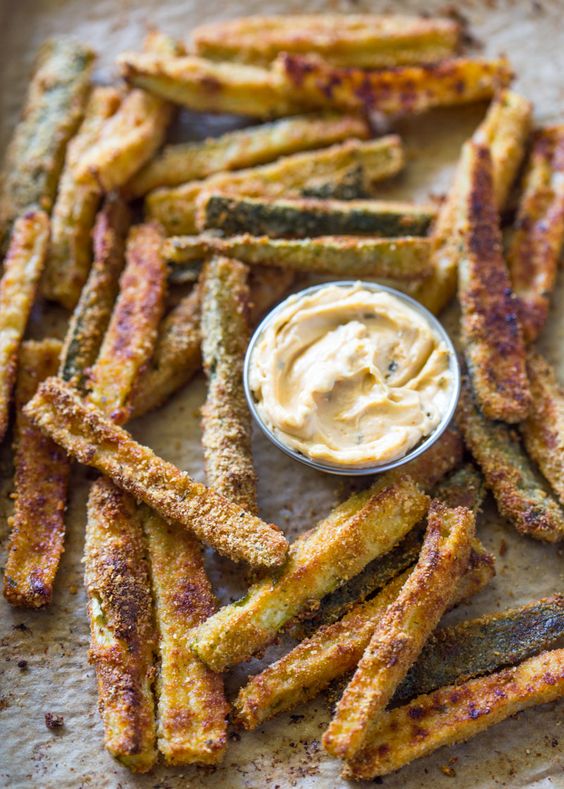 Thinly sliced zucchini dusted in breadcrumbs and baked until crispy and golden is a great alternative to potato fries with less than half the carbs and calories! As many of you have noticed from my