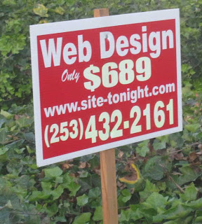 Red and white sign on a stick advertising web design for $698