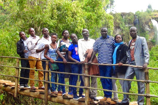 Kenya and Uganda field teams standing on bridge