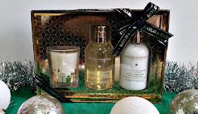 Sweet Mandarin & Grapefruit Festive Trio of Treats gift box surrounded by silver tinsle and baubles