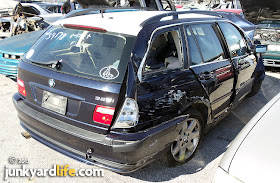 The 2003 BMW Sport Wagon cost more than $30,000 when new. This wrecked Beemer sold for considerably less at auction. 