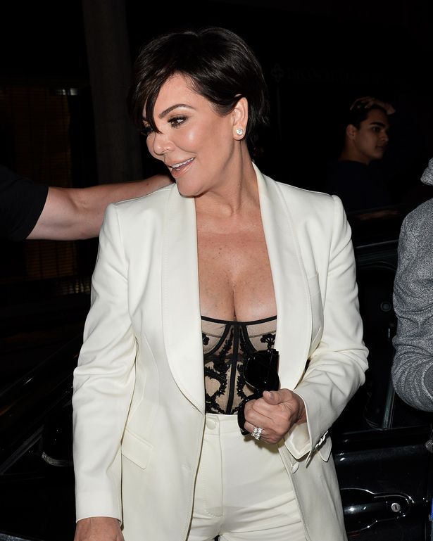 Kris Jenner bares major cleavage in white suit.