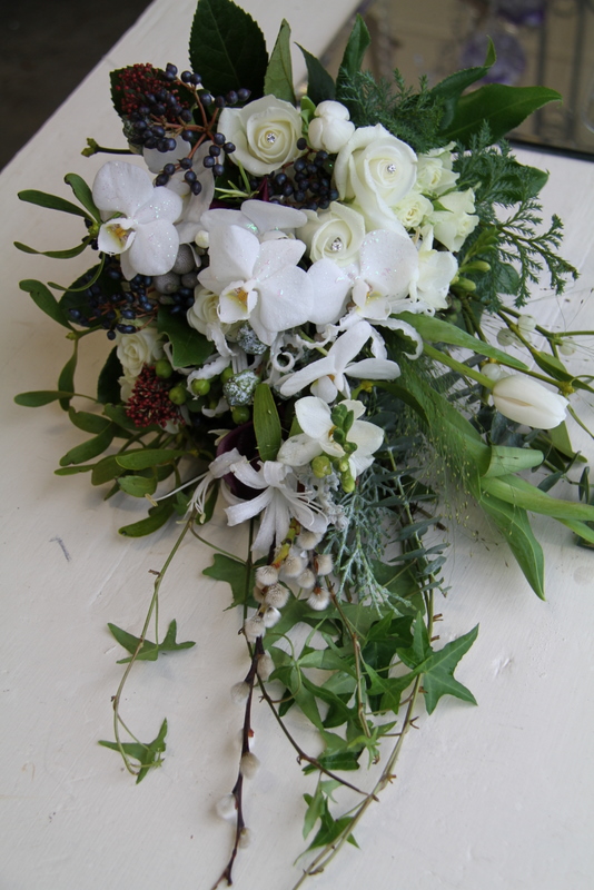Gorgeous trailing white shower wedding bouquet including Roses 