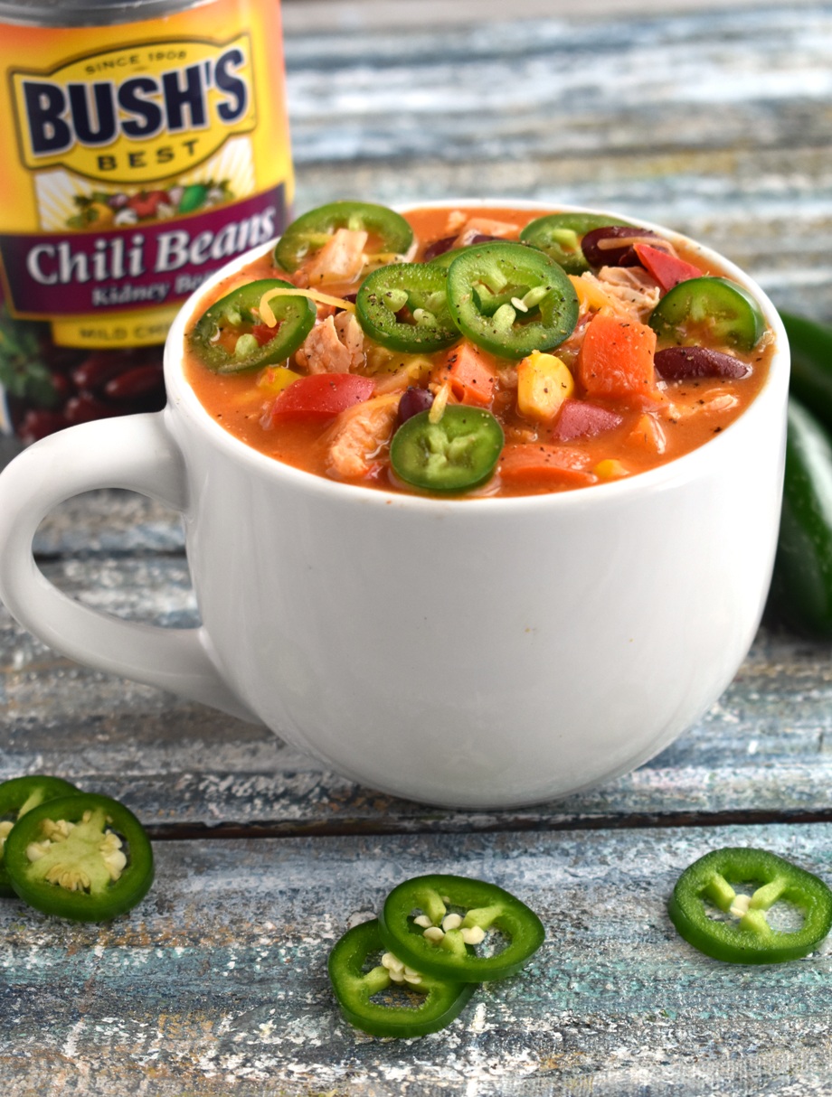 Jalapeno Popper Chicken Chili is the perfect warm and comforting soup with a creamy, cheesy jalapeno popper base, chicken, beans and loads of vegetables! Lightened up for a healthier version that is perfect for a cold day.