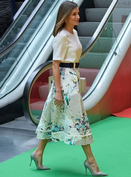 Queen Letizia wore Adolfo Dominguez floral print skirt and she wore Magrit pumps, Hugo Boss satin blouse, carried Magrit clutch bag