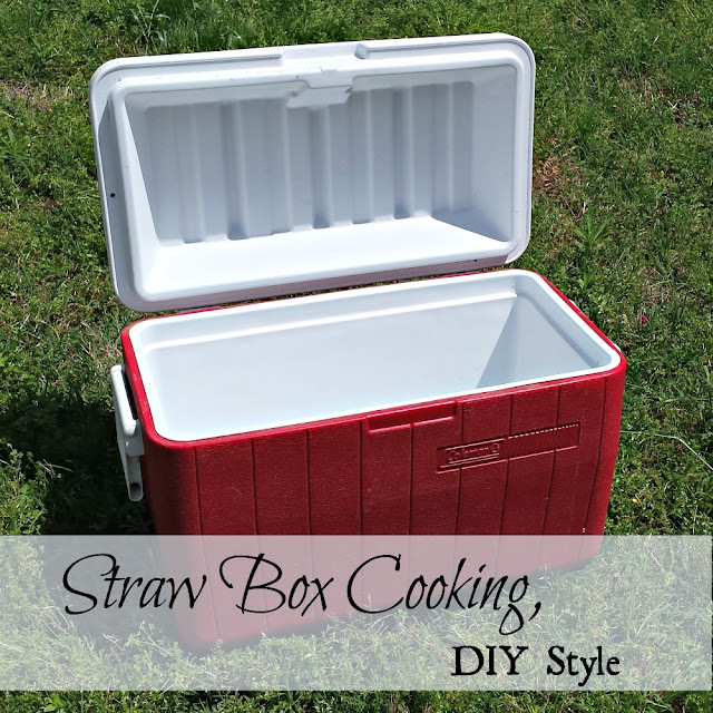A red cooler with a white lid, used to make a straw box cooker (fireless cooker).