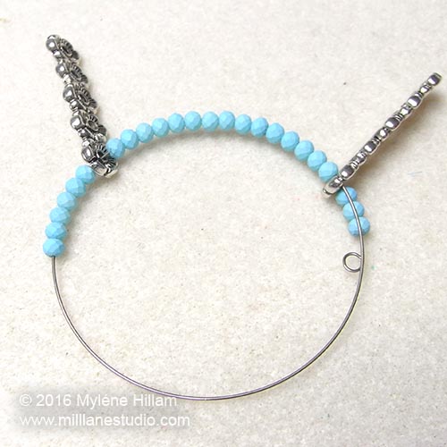 Half the bracelet is strung on the memory wire.