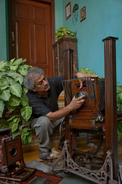 Last weekend I visited  INDIA PHOTO ARCHIVE FOUNDATION and it was a wonderful opportunity to know more about old technologies around Photography and the way one of the great Indian Photographers works. It was a very interactive meet with Aditya Arya, who is one of the famous Indian Photographers and popularly known for his work in 'India Photo Archive Foundation' Before I start sharing about the experience, just check out the video below -(All photographs used in this Photo Journey are picked form different websites or Aditya's Facebook Profile. So none of these are clicked by me)After reaching Aditya's place, we spent some time around his Camera Collection and the place where he has kept archives. INDIA PHOTO ARCHIVE FOUNDATION IS REGISTERED AS PUBLIC CHARITABLE TRUST, a Trust for Creation of awareness of contemporary and historical photographs, creation of archives, and highlighting the historical value of photographic archives and collections and to encourage the dissemination, access and use of such archives for academic, institutional and cultural purposes.Aditya has worked on various books and I also looked at two of his books. One was on Nagaland, where he visited many times to understand the place and people. One of his book 'HISTORY IN THE MAKING' was launched at NCPA, in presence of Bollywood Actor Anupam KherAditya Arya planned some of the exhibitions to showcase photographs clicked by the legendary photographer Kulwant Roy. Roy’s collection of candid moments of Pandit Jawaharlal Nehru, Mahatma Gandhi, and other stalwarts of early 20th century India, are very well preserved by Mr Arya. Roy's collection was inherited by his nephew Aditya Arya, who himself is a professional photographerMore work by Aditya Arya can be checked at - http://www.adityaarya.com/ and to know more about him, check out http://www.adityaarya.com/#/about/bio-info-pagThe Aditya Arya Archive (http://www.adityaaryaarchive.com/) is based on the almost forgotten photographs of the important early Independence movement photographer Kulwant Roy (1914-1984). Founded by his nephew, a professional photographer, the archive is actively pursuing the restoration of other collections on the verge of being lost to history. Twenty five years after the passing of his uncle, Kulwant Roy, when photographer Aditya Arya opened the boxes that had been bequeathed to him, he was astounded. He was looking at a treasurehouse of images of pre- and post-independent India. Photographs systematically organised and annotated, negatives carefully packed together, notes painstaking scribbled at the back of fading photographs.A lifetime of work of photojournalist, Kulwant Roy. And so it was that Aditya Arya’s journey of archiving began. Drawing from a collection of thousands of old prints and cracked negatives, the initial recovery has led to an exhibition of selected works in Delhi, the generation of worldwide interest in Roy’s work, and the establishment of the Aditya Arya Archive.The team at the Archive is led by Aditya Arya, and draws upon the expertise of established archivists, historians, researchers, restorers, designers, writers and filmmakers.Words can never define the amount of efforts, which has gone on this whole project. I was fortunate to visit the place and spend some time with Aditya Arya to know about all this. Aditya has also a huge collection of old cameras of different types. He showed some of the FIRST cameras with some of the specific technologies. E.g.- He showed me first camera with concept of APERTURE. It was huge camera which used to come with rings of different sizes. So whatever aperture is required, photographer needed to change the ring before each shot. Similarly I saw FIRST camera with SHUTTER, which had shutter of think cloth. It was amazing to see wooden 3D viewers. I couldn't click photographs of these wonderful collection-pieces. It was hard to imagine the quality of 3D photographs in 1910 and innovative ways of viewing 3D photographs.After some Tea in the middle of this marvelous collection, we moved towards Digital workspace of Mr. Aditya Arya. Digital Space was even more impressive for me. iMACs with various Hard-Drives and Drobo Boxes for handling hundreds of terabytes. Mr. Arya plays with Lacs of photographs at any point of time. His digital workflows were really exceptional and he is very well equipped to handle this efficiently. Everything very well planned and organized. During this meet, we discussed about various things around Analog & Digital photography. He shared various things about his career and his style of working. Aditya is very detail oriented Photographer who believe in perfectness with his camera & negligible post-processing. During some chit-chat about Lightroom, I got a chance to look into his Raw photographs shot with Mamiya Leaf and all of them were perfect and no retouching was required. Aditya is really very well organized Photographer, who is very well aware of his digital workflows and can independently take care of it. During the conversation he showed me his store which was adjacent to his studio and it was full of equipments which we usually need for electrical, house-keeping or construction work. he is kind of person, who believes in doing things himself and be independent most of the times. I was amazed to notice few things like stone-cutter, weighing machine etc, apart from regular stuff as electrician or plumber uses. All this shows the independt nature of doing his work more efficiently.After all this great chit-chat at Aditya place, we went for dinner at DLF City Club and got some good suggestions from Aditya to be more focussed about Photography. Hope to catch with him again in near future, as such passionate people are good inspirations in life !