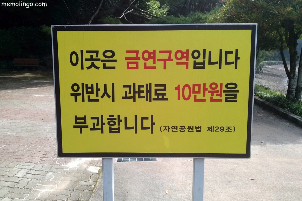Cartel en coreano avisando de multas por fumar
