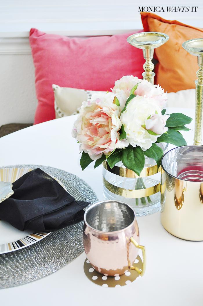 Beautiful breakfast nook makeover with hints of coral, pink, gold and black and white.