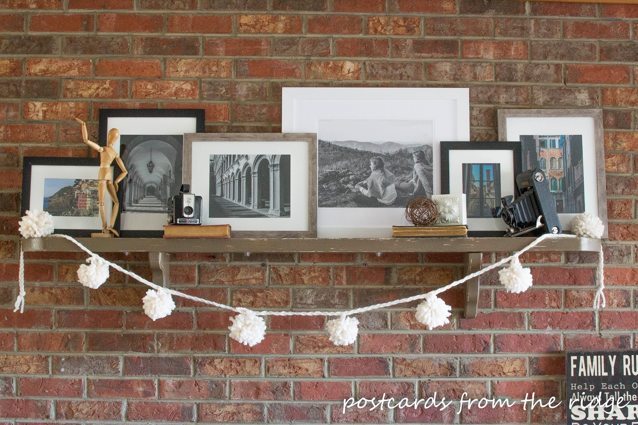 brick fireplace with pom pom garland