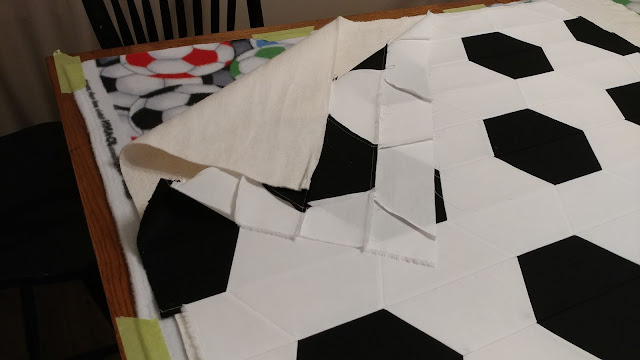 Soccer quilt made with half hexagons