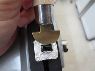 using a bezel pusher to set a tourmaline ring in metal clay ring