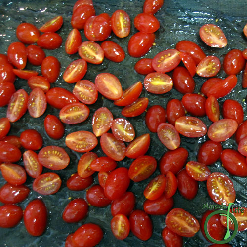 Morsels of Life - Sun Dried Tomatoes Step 2 - Spread tomatoes out on a baking tray. (Optional - If you’re using oil/seasonings, you’ll want to mix the tomatoes with those before putting them on the baking tray.)