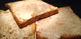 Mayonnaise spread on toasted brown bread  for veg club sandwich recipe