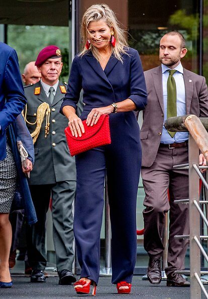 Queen Maxima wore Natan crepe jumpsuit. Queen Maxima's outfit is by Belgian fashion house Natan. red sandals and clutch
