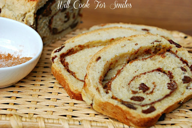Pumpkin Spice Swirl Bread slices with the rest of the loaf and bowl of spice on top of a basket 