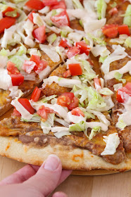 This cheesy tostada pizza is a delicious meatless meal that's super easy to make!