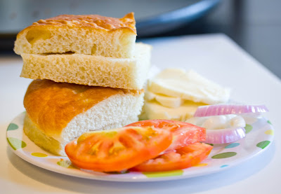 Bread, tomatoes, onions and cheese for a sandwich