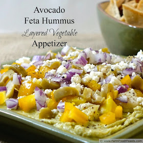 Avocado feta hummus is good as a stand alone dip--but it sings when you layer it with fresh & preserved vegetables and additional cheese then scoop it up with fresh veggies and pita chips.
