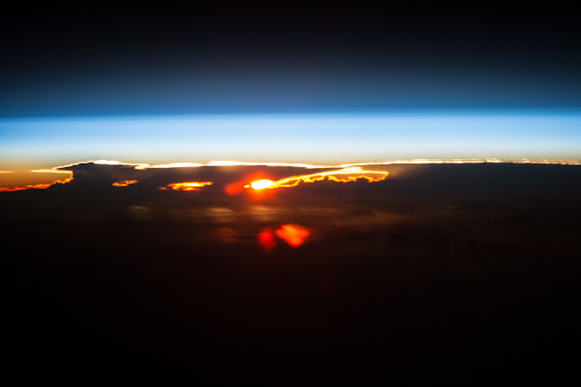 Sun, Earth's Atmosphere and Clouds over Pacific Ocean seen from the International Space Station