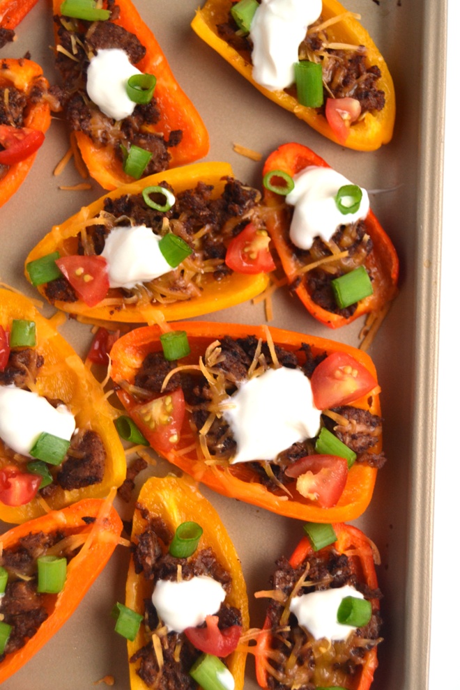  Mini Bell Pepper Nachos are a healthier vegetarian version of your favorite appetizer, ready in just 15 minutes and are topped with cheddar cheese, tomatoes, green onions and more! www.nutritionistreviews.com