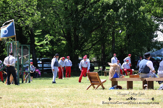 Photo of men playing a baseball game dressed in uniforms from the 1860s. The article is Vintage baseball by rosevinecottagegirls.com